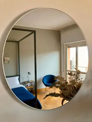a room with a bed and a mirror at Spazioso Appartamento Vicino al Vaticano in Rome