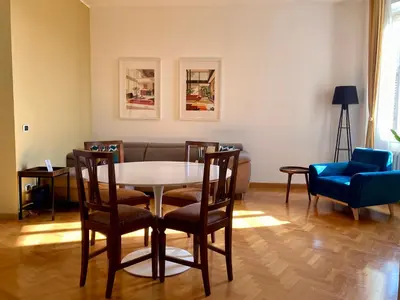 a living room with a table and chairs and a couch at Spazioso Appartamento Vicino al Vaticano in Rome
