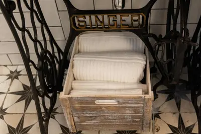 a wooden chair with a white mattress in a basket at Khris Home Apartments - Trastevere - San Cosimato in Rome