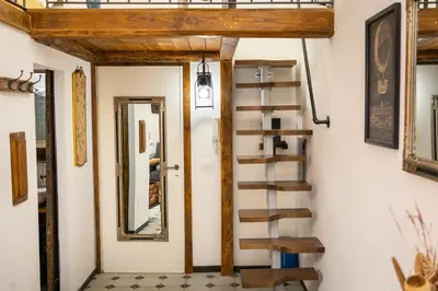 a spiral staircase in a room with a mirror at Khris Home Apartments - Trastevere - San Cosimato in Rome