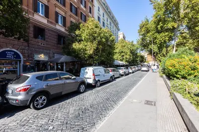 a row of cars parked on the side of a street at Khris Home Apartments - Trastevere - San Cosimato in Rome