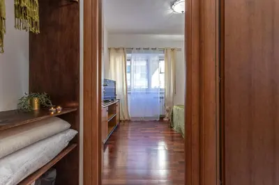 a hallway with a door leading to a living room at Hope Home in Rome