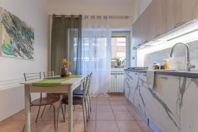 a kitchen with a table and chairs and a sink at Hope Home in Rome