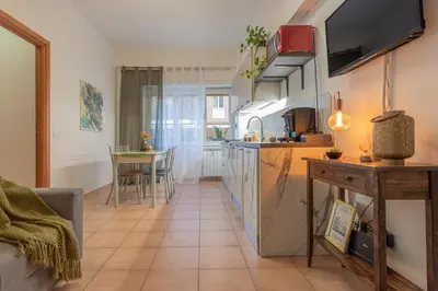 a kitchen and a living room with a table at Hope Home in Rome