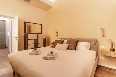 a bedroom with a bed with towels on it at iFlat Augustus Suite near Pantheon in Rome