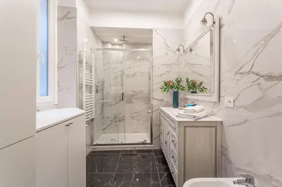a white bathroom with a shower and a sink at iFlat Augustus Suite near Pantheon in Rome