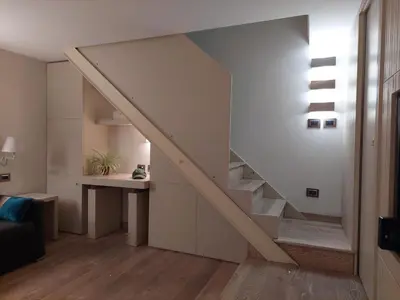 a staircase in a living room with a table at La Dimora di Roma in Rome