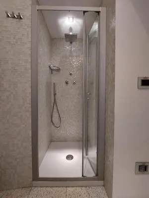 a shower with a glass door in a bathroom at La Dimora di Roma in Rome