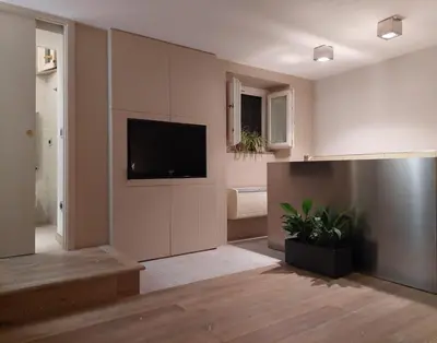 a living room with a flat screen tv on a wall at La Dimora di Roma in Rome