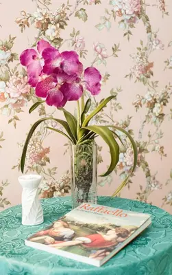 a vase with purple flowers sitting on a table at Apartment Glatimia -Your Home In The Heart Of Rome in Rome