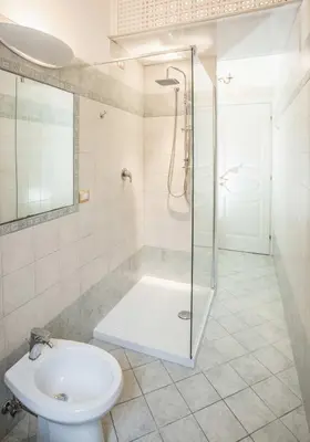 a bathroom with a shower and a toilet and a sink at Apartment Glatimia -Your Home In The Heart Of Rome in Rome
