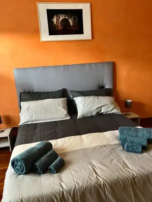 a bed with two pillows on it in a room at Ulisse home in Rome
