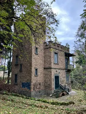 an old stone house with a staircase in a field at Ulisse home in Rome