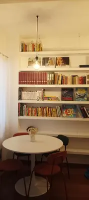 a bedroom with two beds and a night stand with a bedskirts at Design e comfort nel cuore del Pìgneto! in Rome