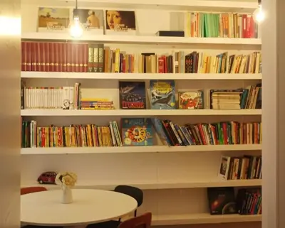 a red coffee maker sitting on a shelf at Design e comfort nel cuore del Pìgneto! in Rome