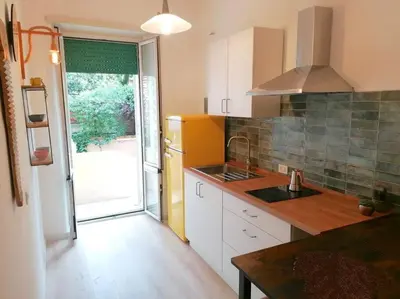 a kitchen with a sink and a door to a yard at Art House in Rome