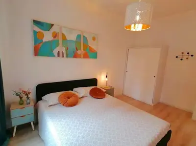 a bedroom with a bed with orange pillows on it at Art House in Rome