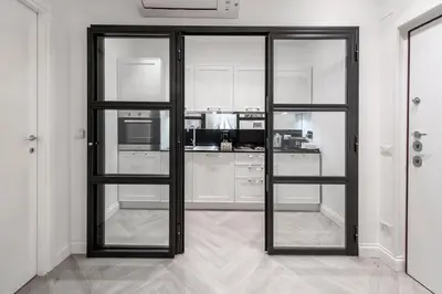 a kitchen with black framed glass doors in a room at Trevi Apartment in Rome