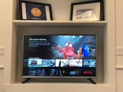 a flat screen tv in a room with shelves at Trevi Apartment in Rome