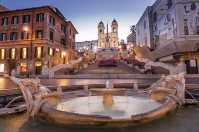 a fountain in the middle of a city with buildings at Trevi Apartment in Rome