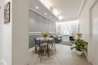 a dining room with a table and a couch at Trevi Apartment in Rome