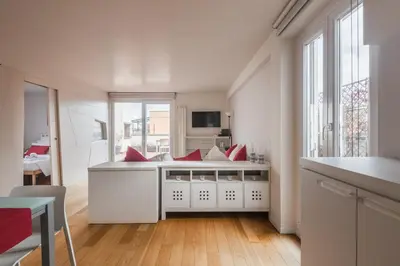 a white kitchen with red pillows on a counter at Appartamento con terrazzo - vicino centro di Roma in Rome