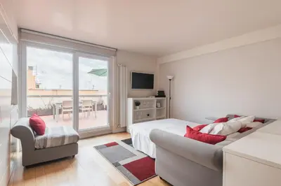 a bedroom with a bed and a couch and a window at Appartamento con terrazzo - vicino centro di Roma in Rome