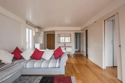 a living room with a white couch with red pillows at Appartamento con terrazzo - vicino centro di Roma in Rome