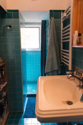 a blue bathroom with a sink and a window at Lovely Sanctuary Central in Rome