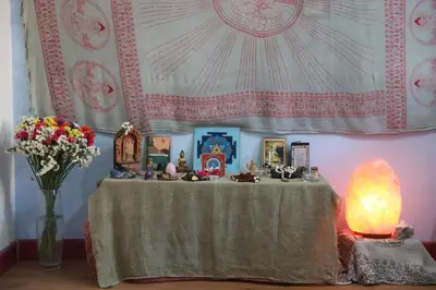 a table with a vase of flowers and a curtain at Lovely Sanctuary Central in Rome