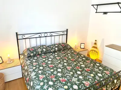 a bedroom with a bed with a floral bedspread at A&G central stay in Rome