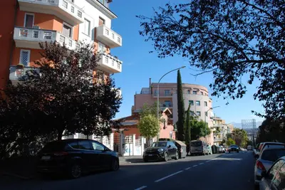 a street with cars parked on the side of a building at A&G central stay in Rome