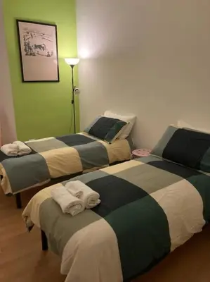two beds in a room with green walls at Casa di Nonna, Piazza Navona in Rome