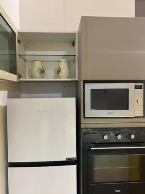 a kitchen with a microwave oven and a refrigerator at Casa di Nonna, Piazza Navona in Rome