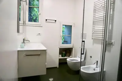a white bathroom with a sink and a toilet at Casa di Nonna, Piazza Navona in Rome