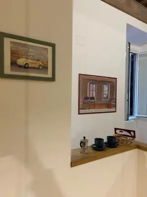 a room with a shelf with a picture of a car on the wall at Casa di Nonna, Piazza Navona in Rome