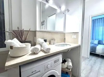 a kitchen with a sink and a washing machine at Appartamento Metro A e Vaticano Maroma in Rome