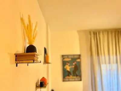 a room with a shelf with books and a vase at Appartamento Metro A e Vaticano Maroma in Rome