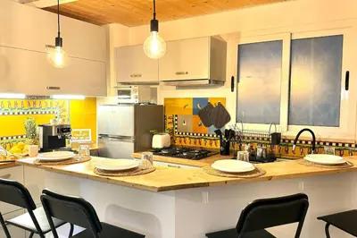 a kitchen with a counter top with chairs in it at Appartamento Metro A e Vaticano Maroma in Rome