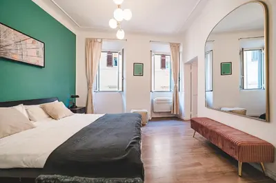 a bedroom with a large bed and a mirror at Cosy Colosseum in Rome