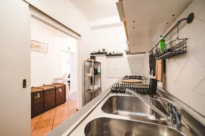 a kitchen with a stainless steel sink in a room at Cosy Colosseum in Rome