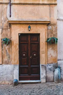 a wooden door on the side of a building at Cosy Colosseum in Rome