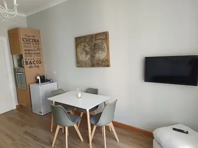 a dining room with a white table and chairs at S Peter suite appartamento ristrutturato in centro in Rome
