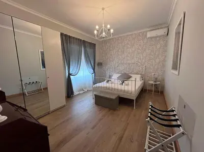 a bedroom with a bed and a room with a mirror at S Peter suite appartamento ristrutturato in centro in Rome