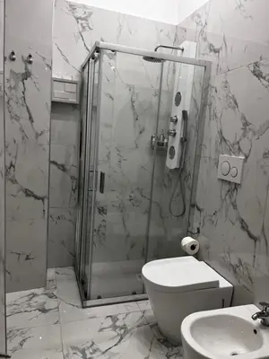 a bathroom with a shower and a toilet and a sink at Gold House Roma in Rome