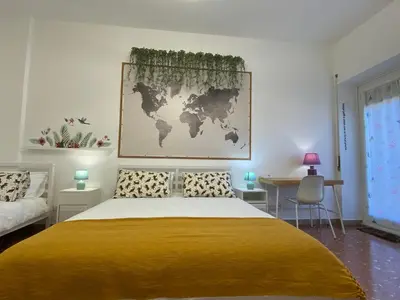 a bedroom with a large bed with a yellow blanket at Way of Saying CASA in Rome