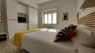 a bedroom with a large white bed and a window at Way of Saying CASA in Rome