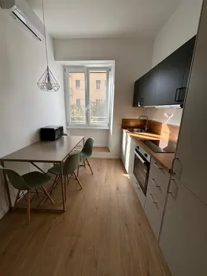 a kitchen with a table and chairs in a room at Maison Alteri in Rome