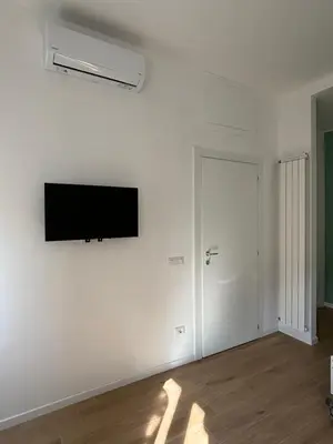 an empty room with a flat screen tv on a wall at Maison Alteri in Rome