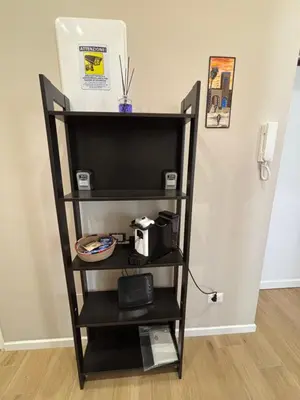 a black book shelf with a tv on it at Maison Alteri in Rome